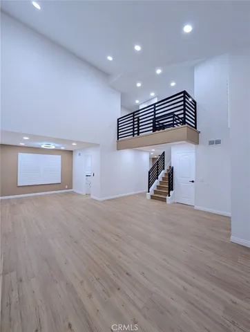 a room with wooden floor and a ceiling fan
