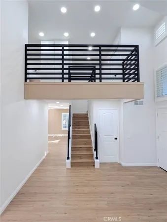 an empty room with wooden floor and fireplace