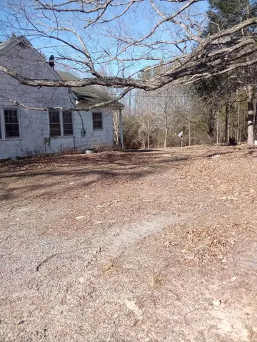 a view of a yard with trees