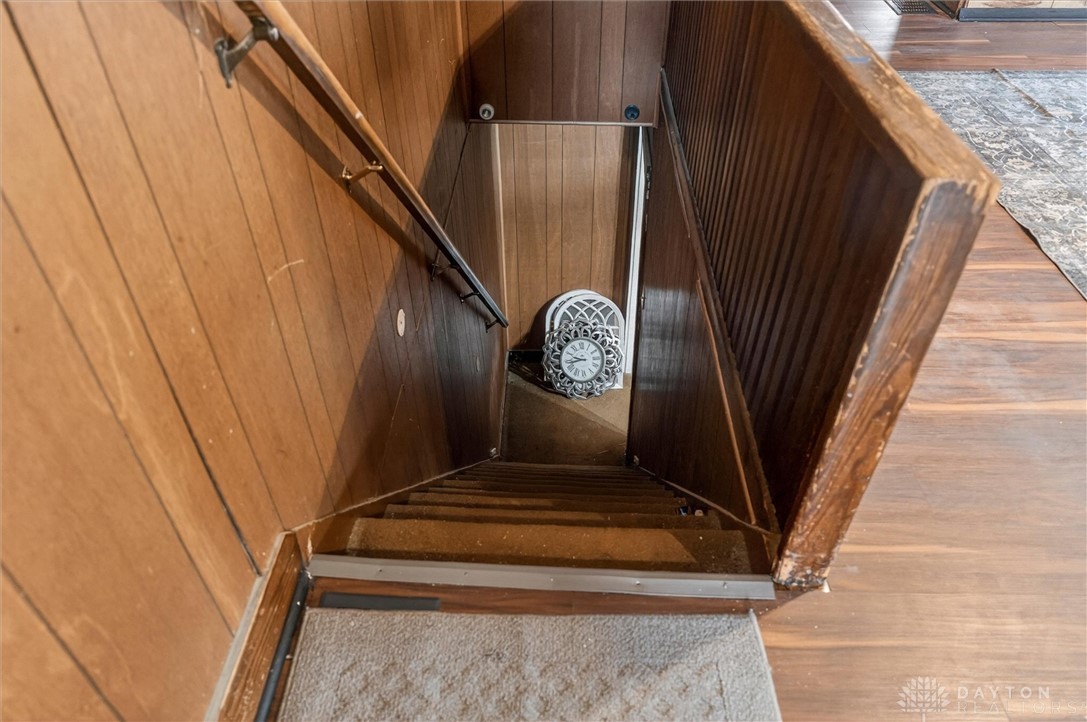1726 Morgan Street Springfield, OH 45503 - Photo 22 of 30 Descend into this inviting space, where classic wood paneling frames a journey to the lower level.