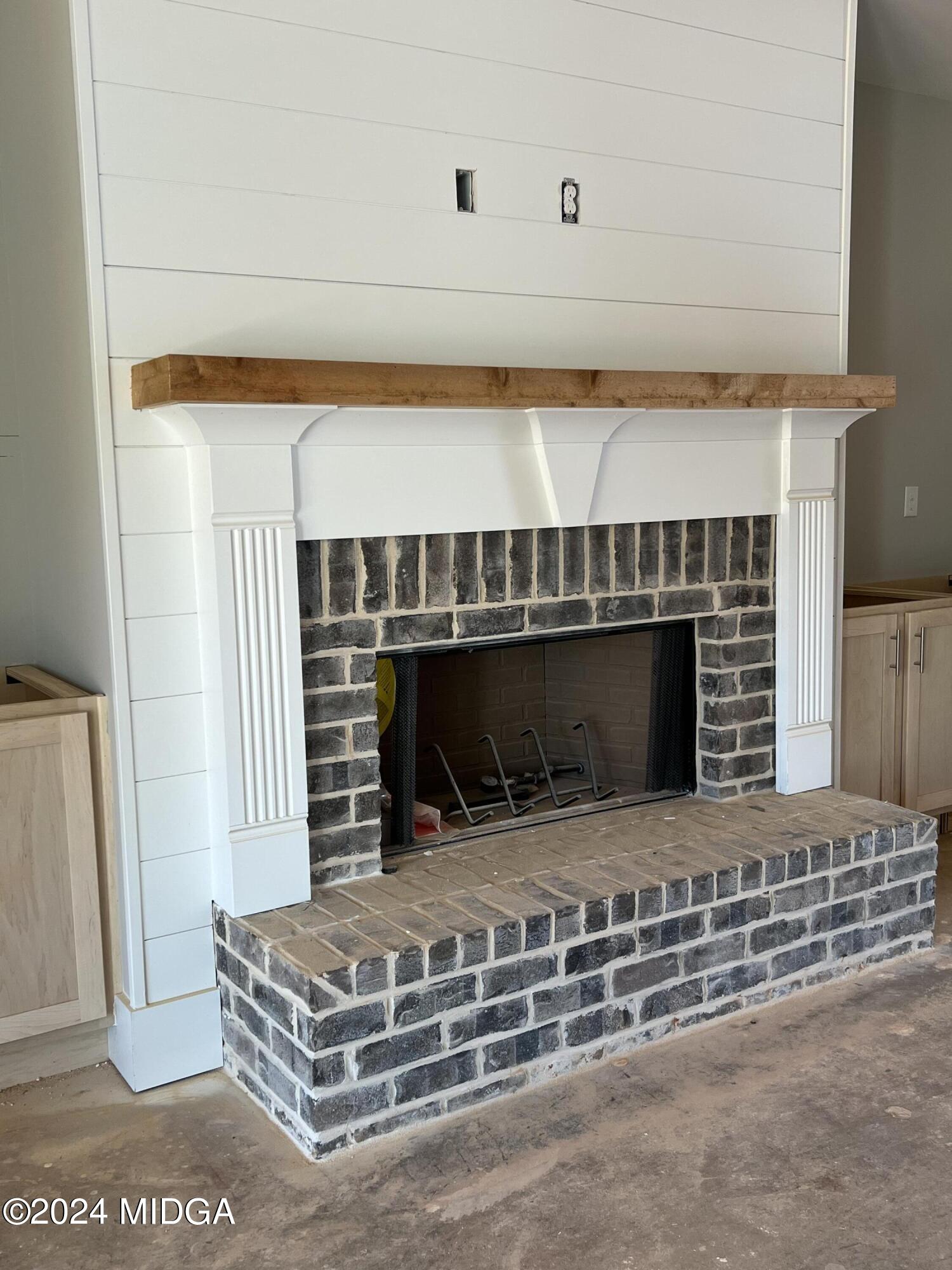 208 Copper Crossing Forsyth, GA 31029 - Photo 11 of 23 a living room with a fireplace wooden floor and a rug