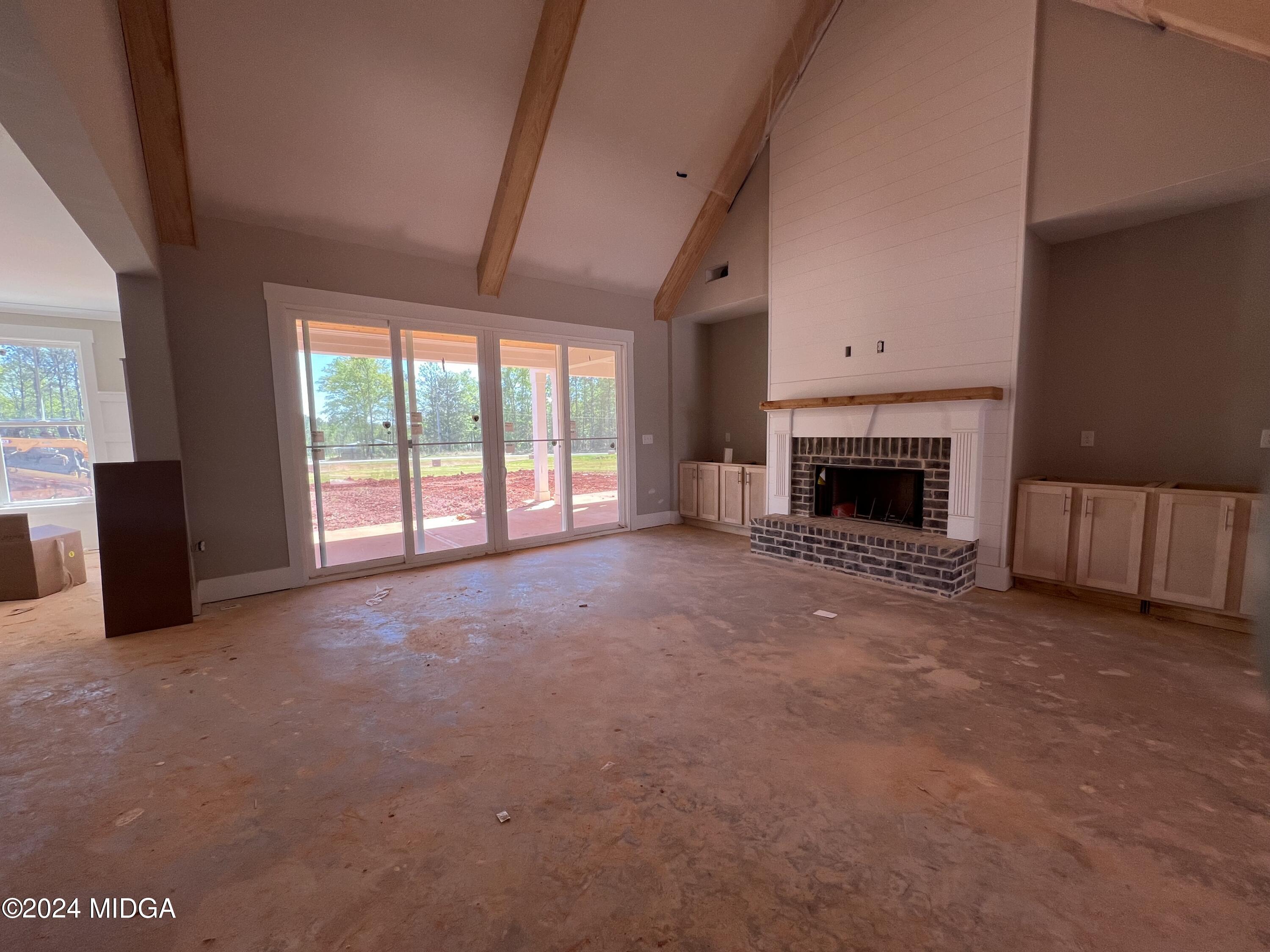 208 Copper Crossing Forsyth, GA 31029 - Photo 12 of 23 an empty room with furniture and a fireplace