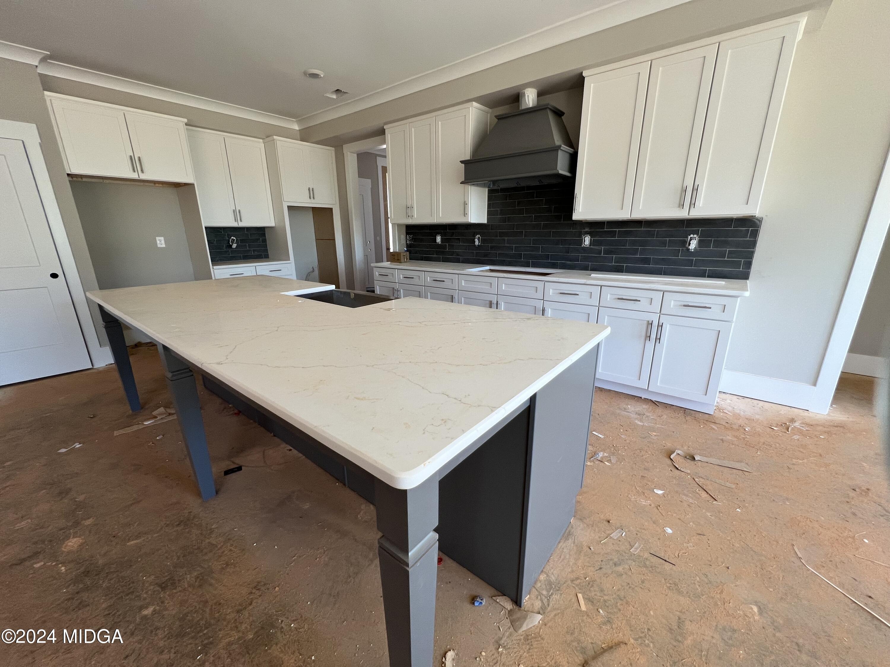 208 Copper Crossing Forsyth, GA 31029 - Photo 15 of 23 a kitchen with kitchen island cabinets and wooden floor