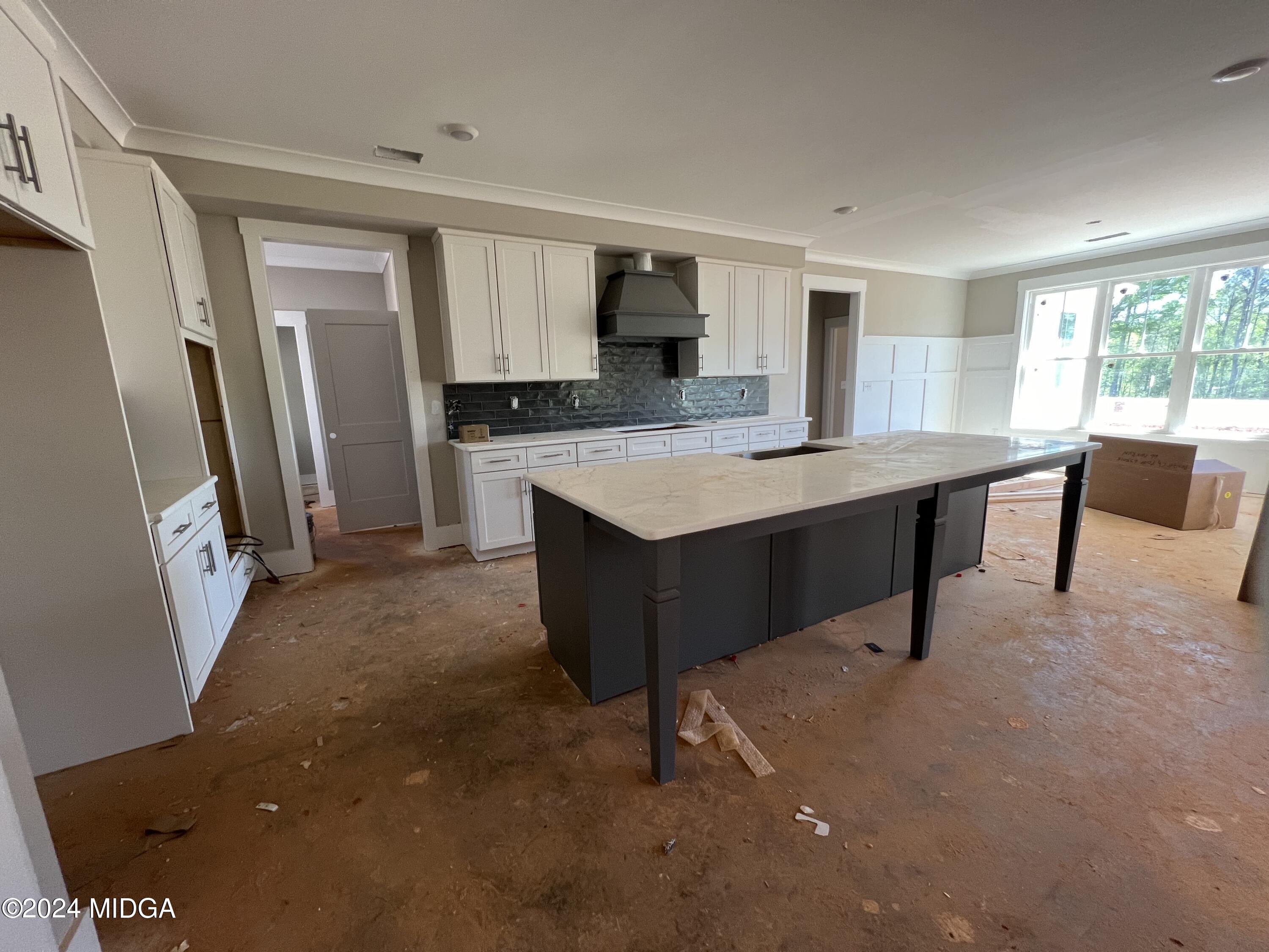 208 Copper Crossing Forsyth, GA 31029 - Photo 16 of 23 a room with a table chairs a refrigerator and a sink
