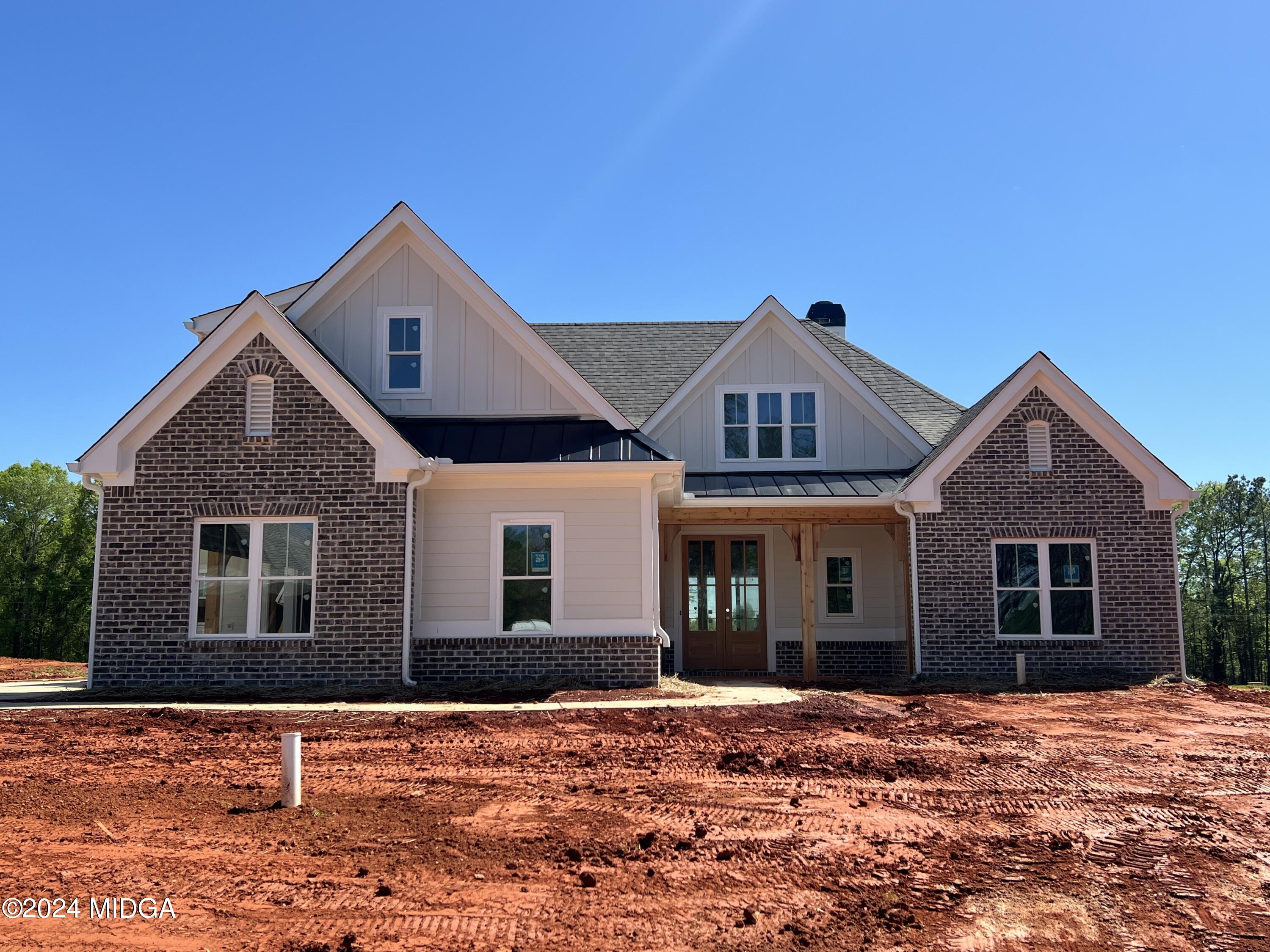208 Copper Crossing Forsyth, GA 31029 - Photo 2 of 23 a front view of a house with a yard
