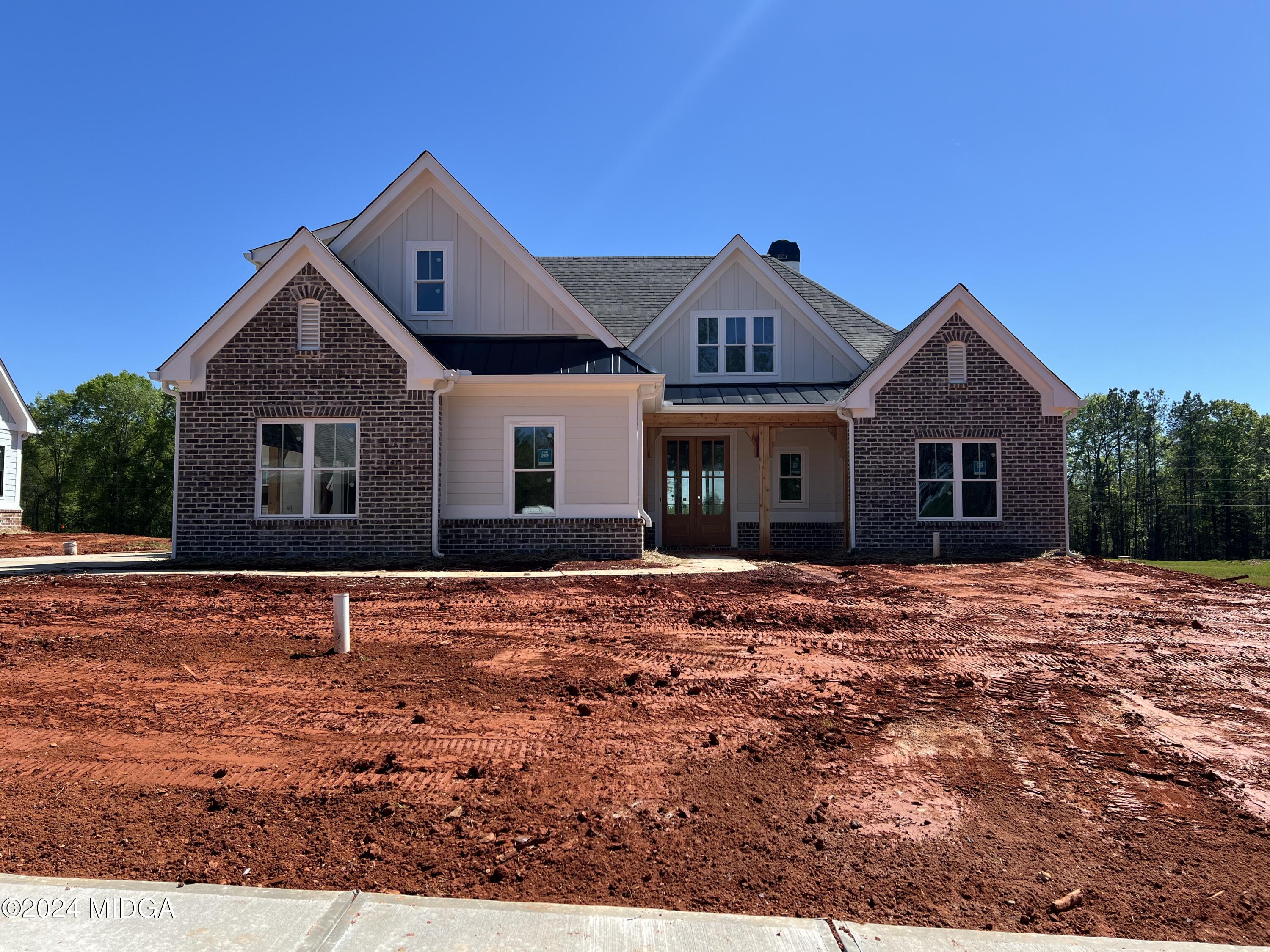 208 Copper Crossing Forsyth, GA 31029 - Photo 3 of 23 a front view of a house with a yard