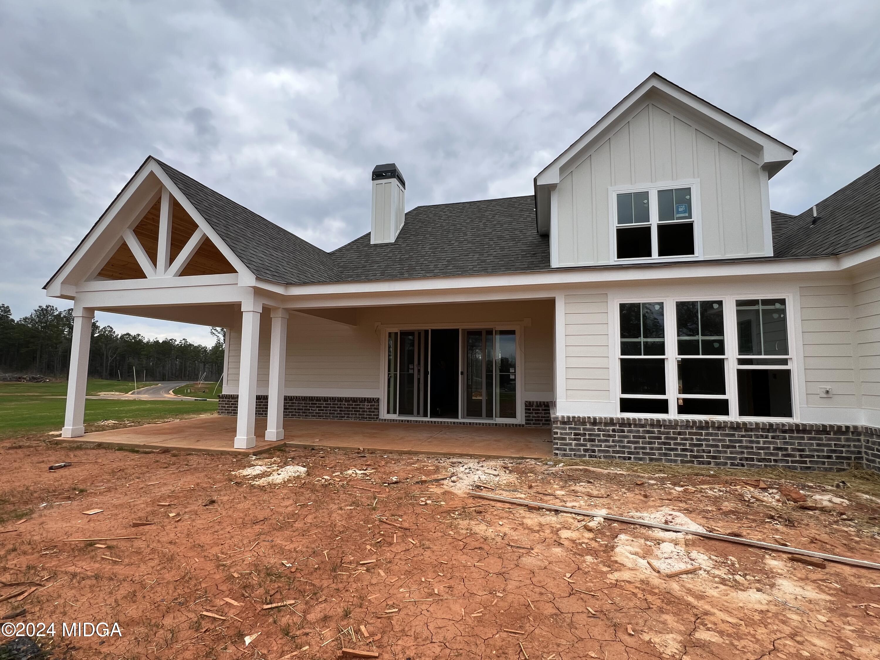 208 Copper Crossing Forsyth, GA 31029 - Photo 8 of 23 a front view of a house with garden