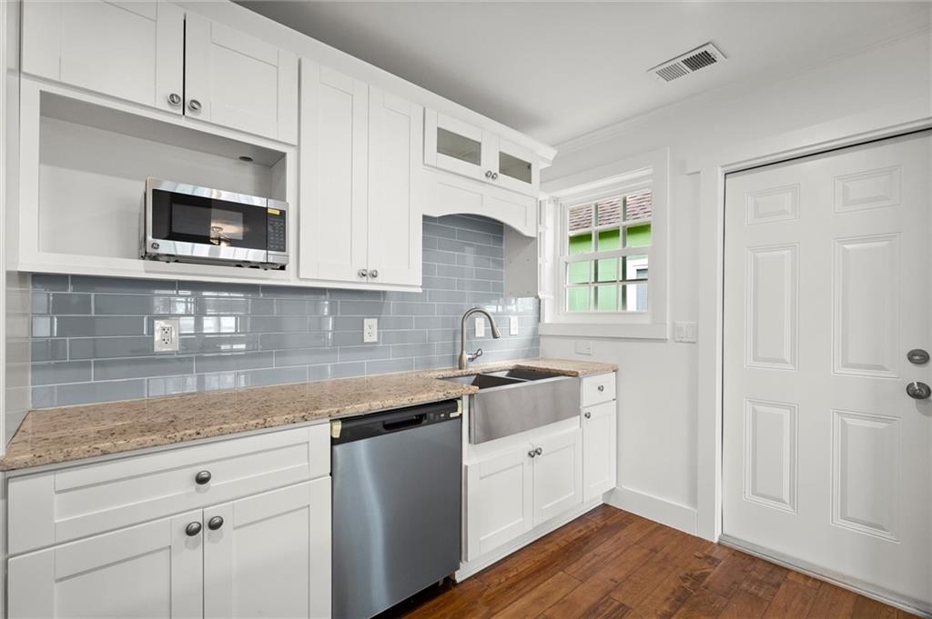 481 Griffin Street Northwest Atlanta, GA 30318 - Photo 11 of 30 a kitchen with stainless steel appliances granite countertop a sink and a microwave