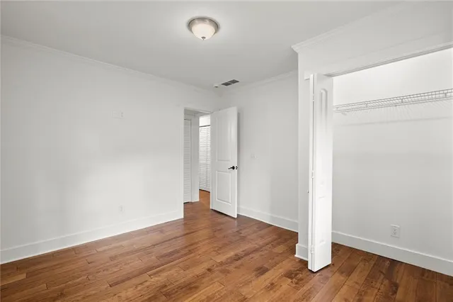 a view of a room with wooden floor