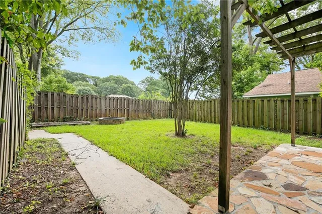 a view of a backyard with a swing