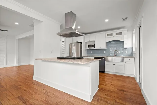 a kitchen with stainless steel appliances granite countertop a stove a sink and a refrigerator