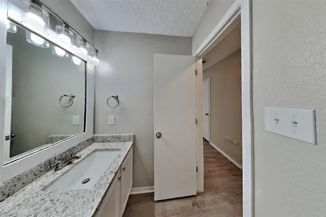 a bathroom with a tub sink and mirror