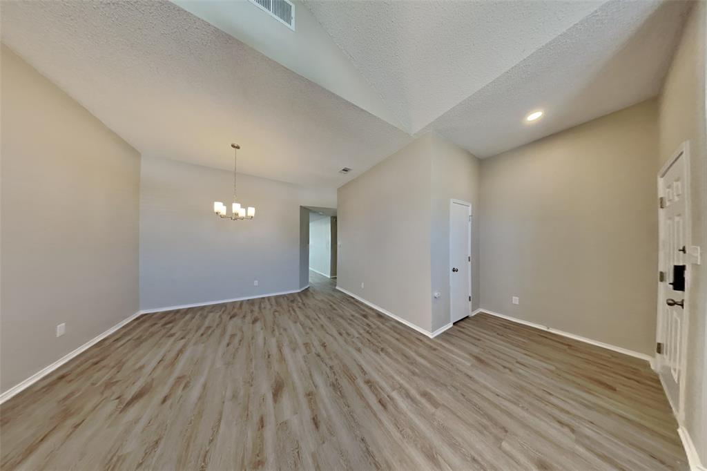1924 Overland Street Fort Worth, TX 76131 - Photo 24 of 27 an empty room with wooden floor and windows