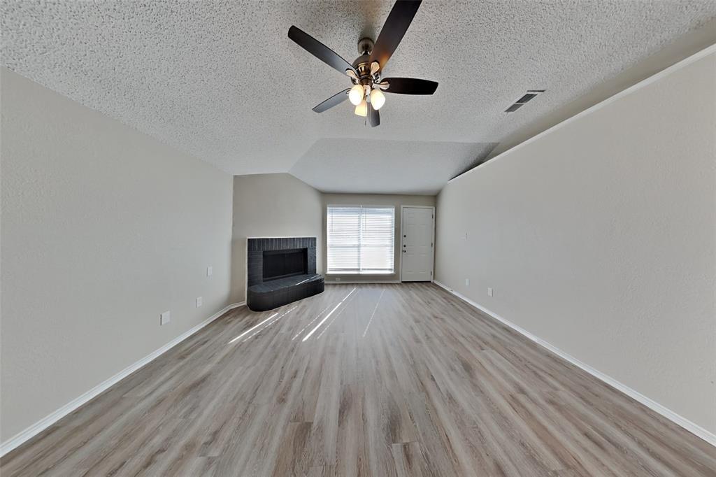 1924 Overland Street Fort Worth, TX 76131 - Photo 4 of 27 wooden floor in an empty room with a window