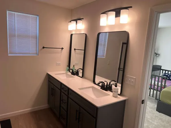 a bathroom with 2 sink and a mirror