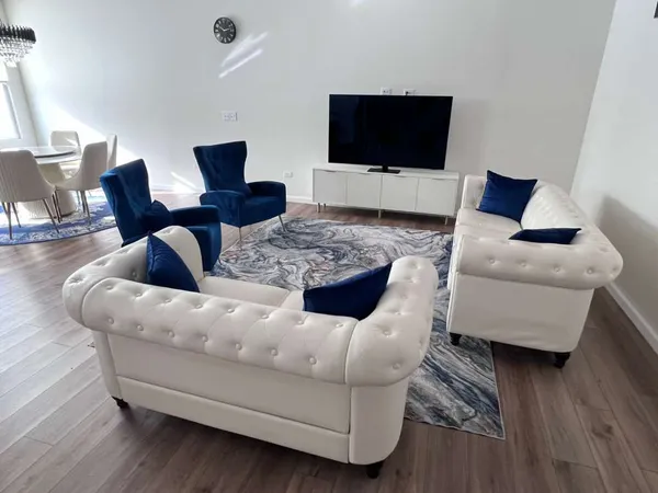 a living room with furniture and a flat screen tv