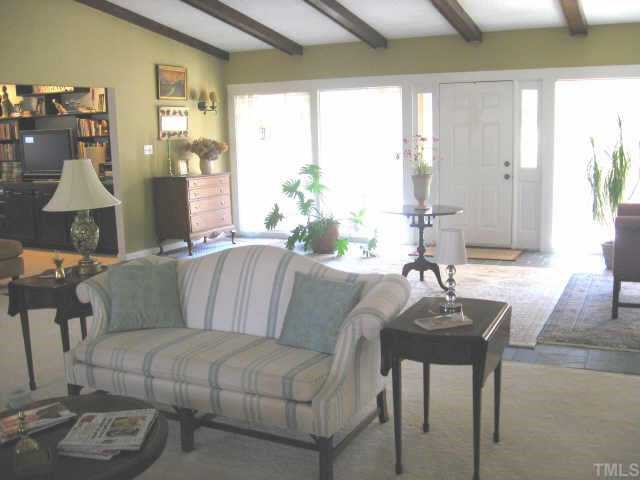 7229 Kemp Road Raleigh, NC 27613 - Photo 10 of 12 a living room with furniture and a chandelier