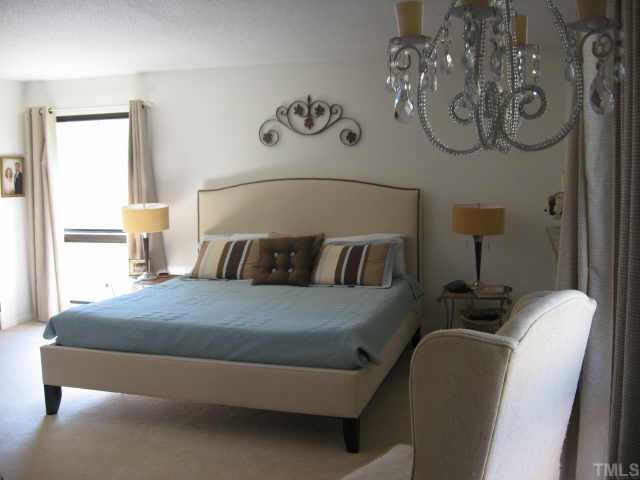 7229 Kemp Road Raleigh, NC 27613 - Photo 6 of 12 a bedroom with a bed and window
