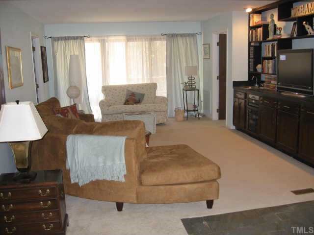 7229 Kemp Road Raleigh, NC 27613 - Photo 8 of 12 a living room with furniture a flat screen tv and a window