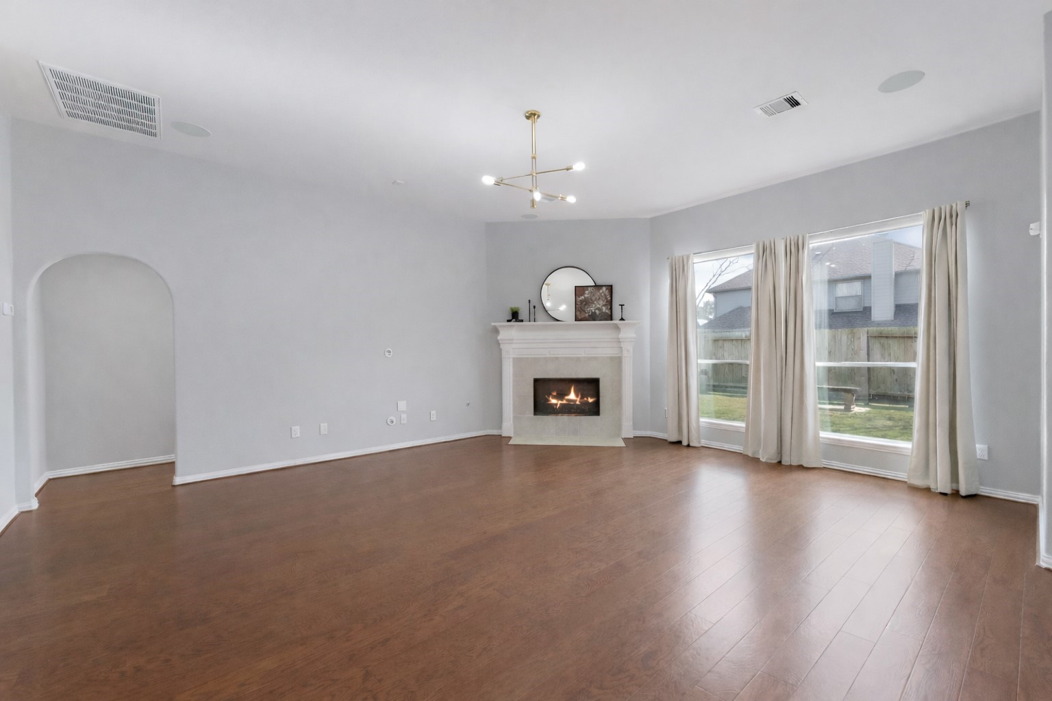 27515 Chris Ridge Court Spring, TX 77386 - Photo 12 of 29 Another view of the living room. Just off the living room is the hallway to the primary suite.