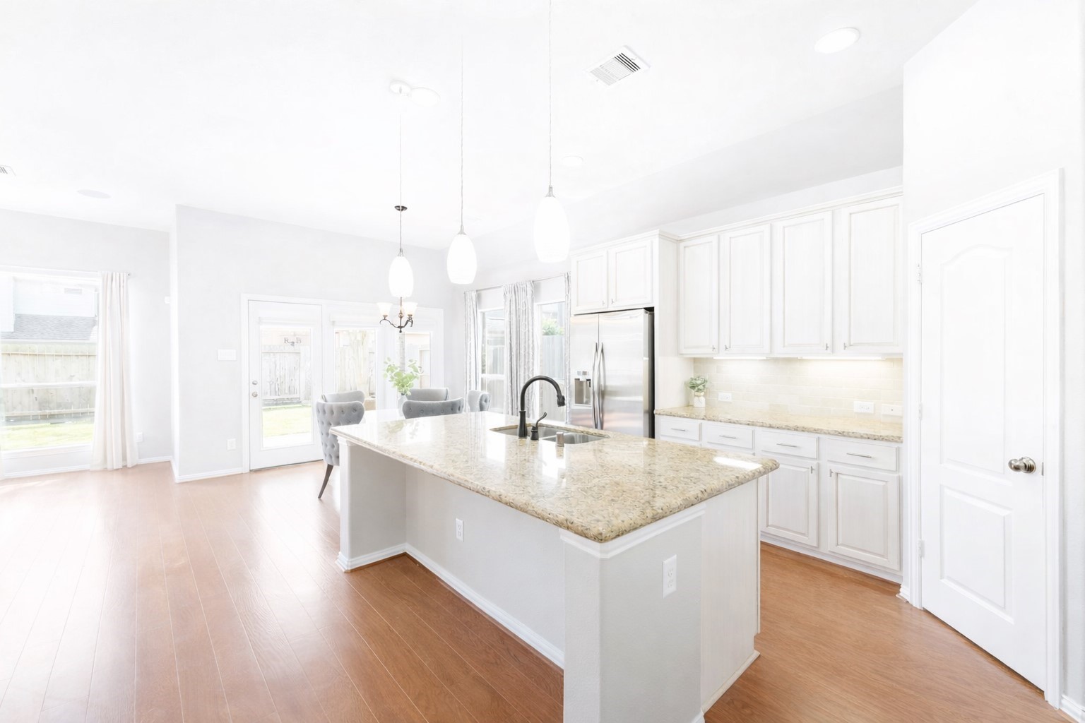 27515 Chris Ridge Court Spring, TX 77386 - Photo 8 of 29 Just past the formal dining room, you enter into the light and bright kitchen space which is open to the large breakfast area and living room.