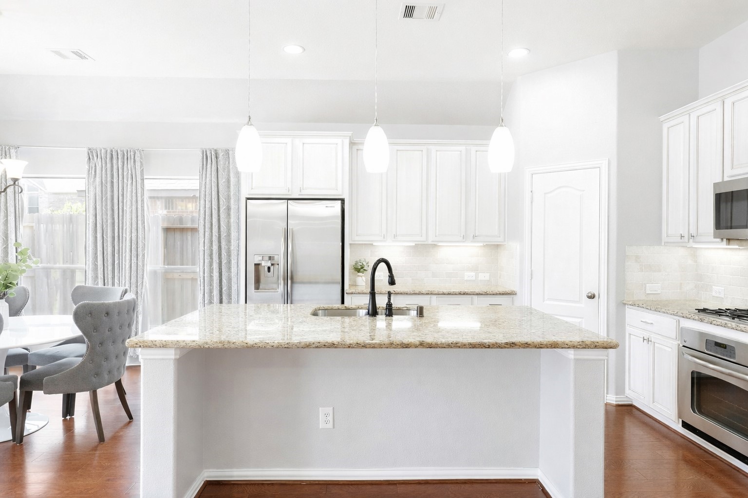 27515 Chris Ridge Court Spring, TX 77386 - Photo 9 of 29 Enjoy this chefs kitchen with granite countertops, white cabinets, updated backsplash and stainless steel appliances.