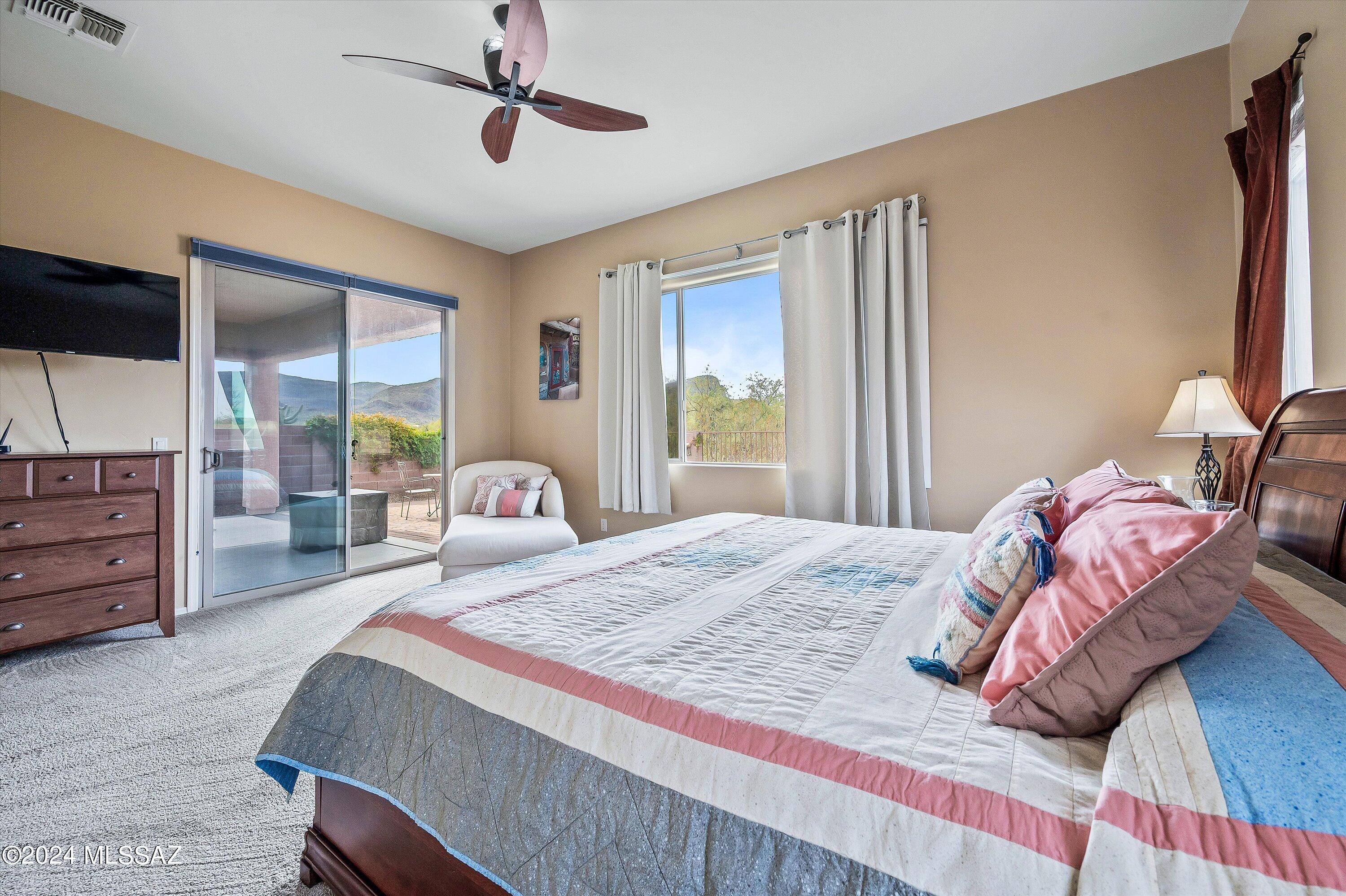 8579 North Shadow Wash Way Tucson, AZ 85743 - Photo 22 of 34 a bedroom with a bed and wooden floor