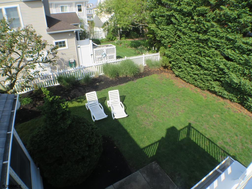 814 Wesley Road Ocean City, NJ 08226 - Photo 25 of 29 a view of a back yard of the house and green space
