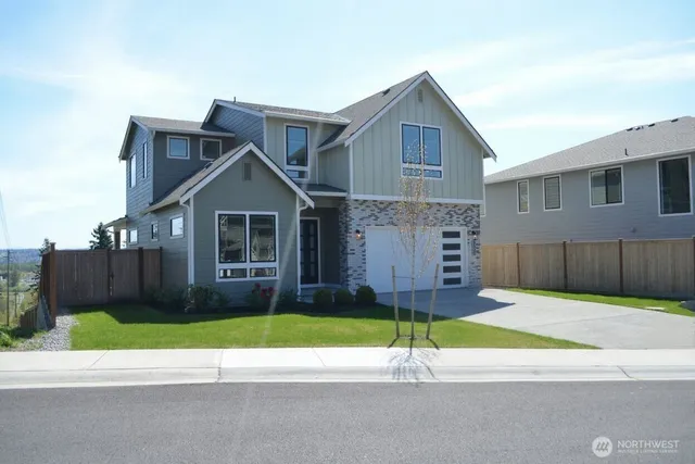 a house with a small yard and a car parked in front of it