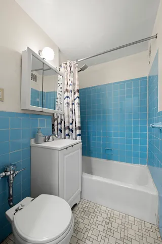 a bathroom with a sink a toilet and bathtub