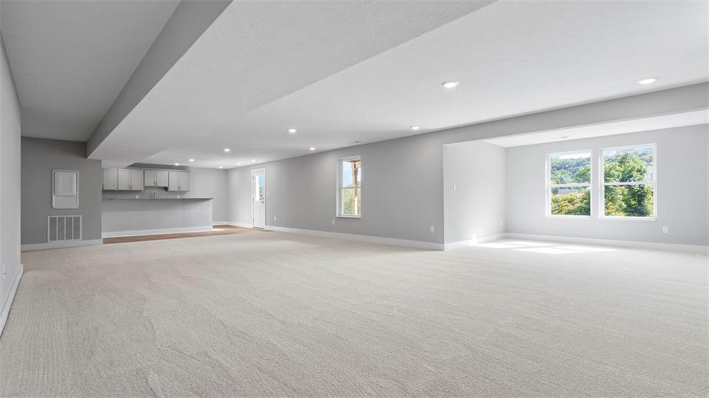 264 Rylie Drive Harmony, PA 16037 - Photo 24 of 31 an empty room with windows and pillars in it