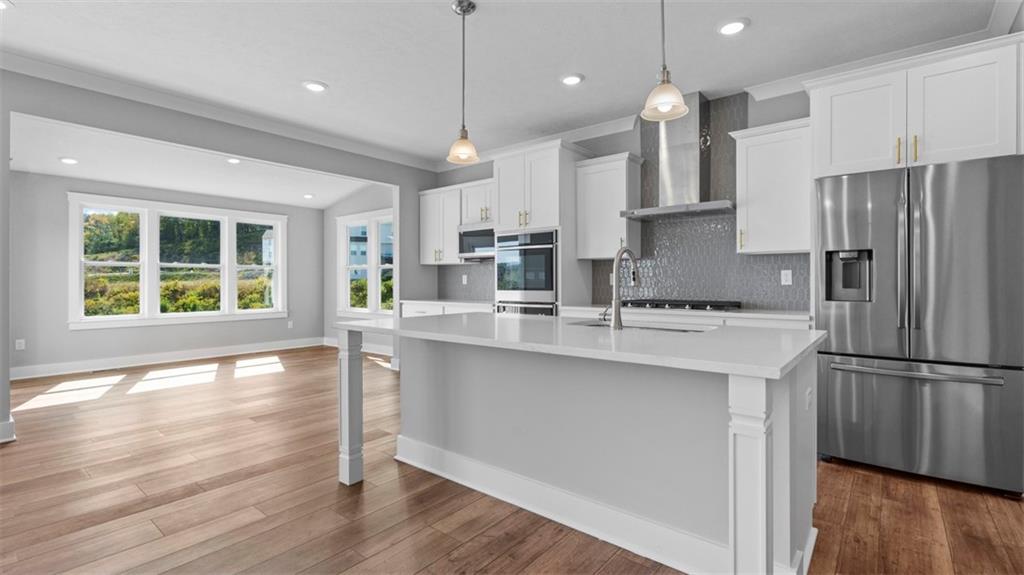 264 Rylie Drive Harmony, PA 16037 - Photo 5 of 31 a kitchen with stainless steel appliances granite countertop a refrigerator a sink dishwasher a stove and white cabinets with wooden floor