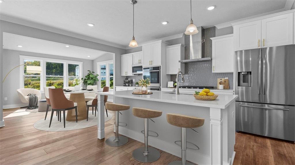 264 Rylie Drive Harmony, PA 16037 - Photo 6 of 31 a kitchen with stainless steel appliances granite countertop a refrigerator a stove a sink a dining table and chairs with wooden floor