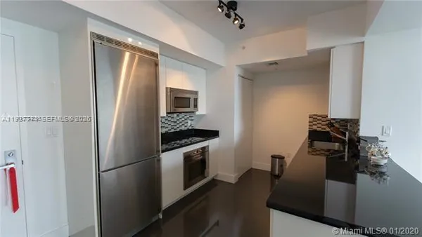 a kitchen with a refrigerator and a stove