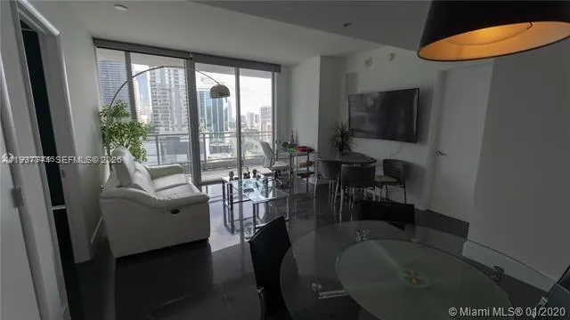 a view of living room with furniture and a floor to ceiling window