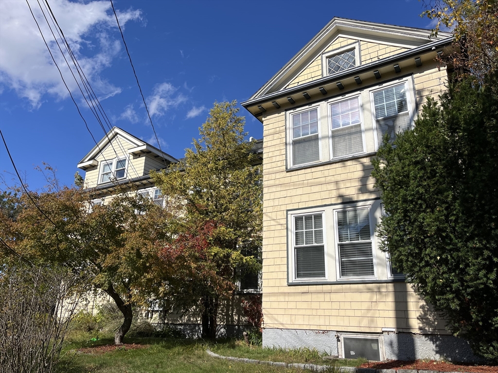65-67 St James Circle, Unit 2 Newton, MA 02458 - Photo 28 of 29 a front view of a house with a yard