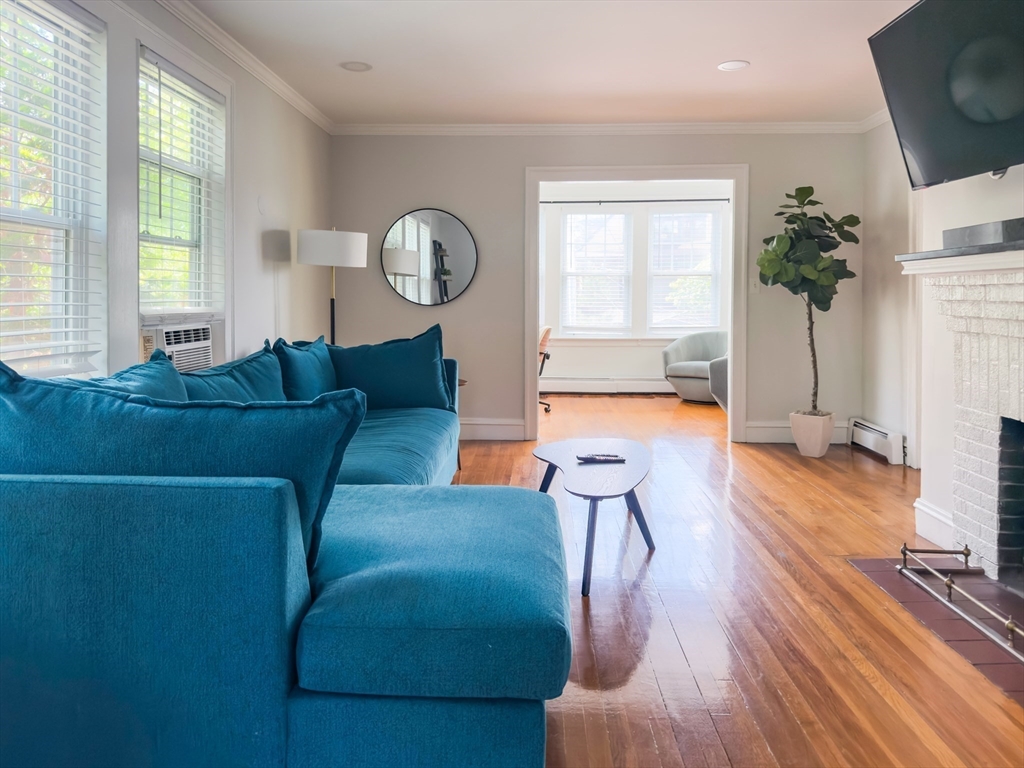65-67 St James Circle, Unit 2 Newton, MA 02458 - Photo 4 of 29 a living room with furniture and a large window
