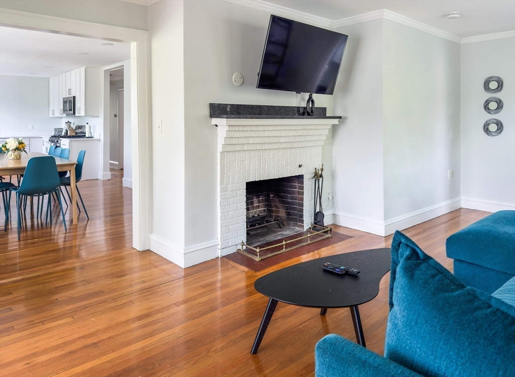65-67 St James Circle, Unit 2 Newton, MA 02458 - Photo 8 of 29 a living room with furniture and a fireplace