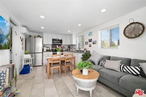 a kitchen with stainless steel appliances a sink a counter top space cabinets and a potted plant