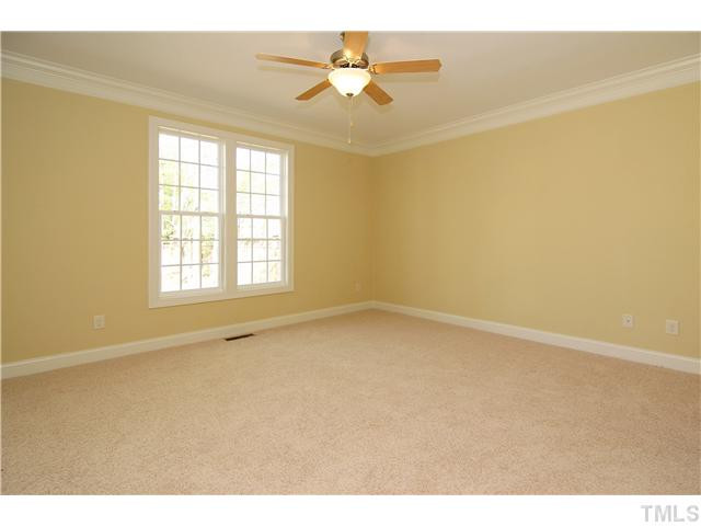204 Redhill Road Holly Springs, NC 27540 - Photo 12 of 25 Spacious 1st Floor Master bedrom with awesome spa like bath and walk in closets with custom wood shelving. Master Bedroom