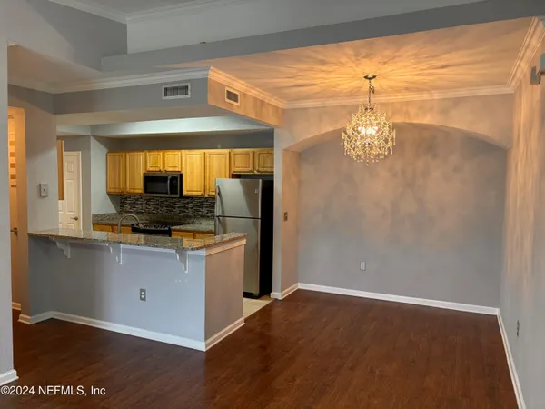 a kitchen with stainless steel appliances granite countertop a sink and a refrigerator
