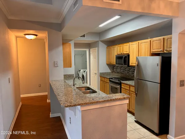a kitchen with a refrigerator a stove and a sink