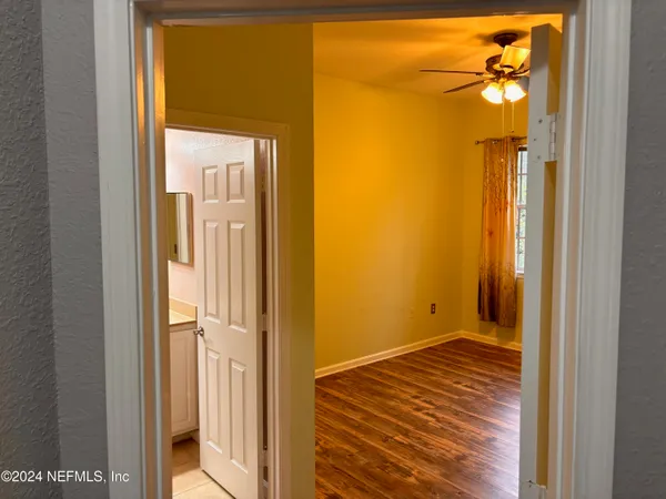 a view of a bathroom with a glass door and a window