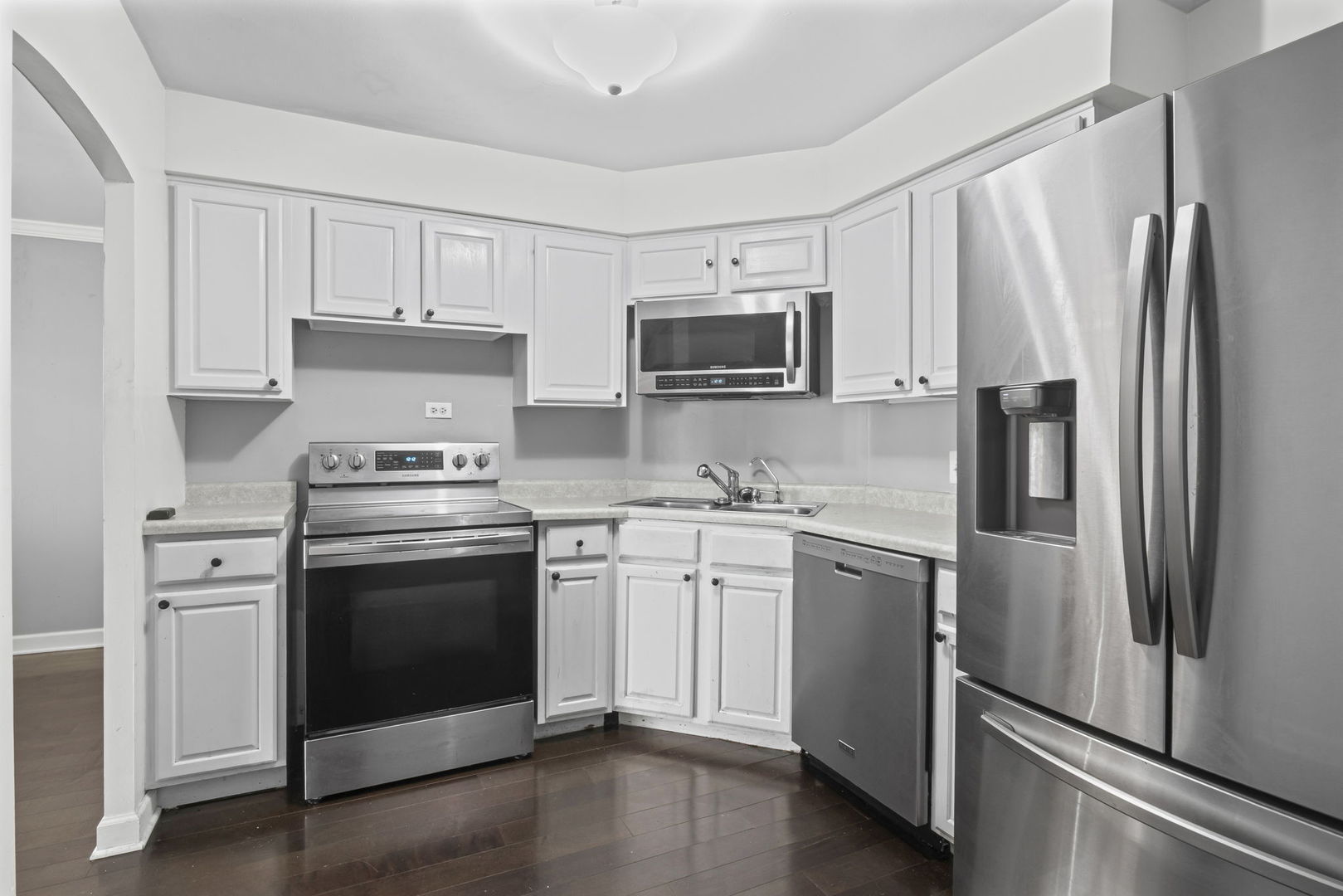 6033 North Sheridan Road, Unit 10D Chicago, IL 60660 - Photo 11 of 24 a kitchen with white cabinets and stainless steel appliances