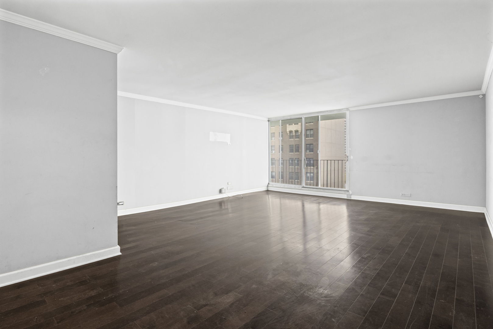 6033 North Sheridan Road, Unit 10D Chicago, IL 60660 - Photo 6 of 24 an empty room with wooden floor and windows