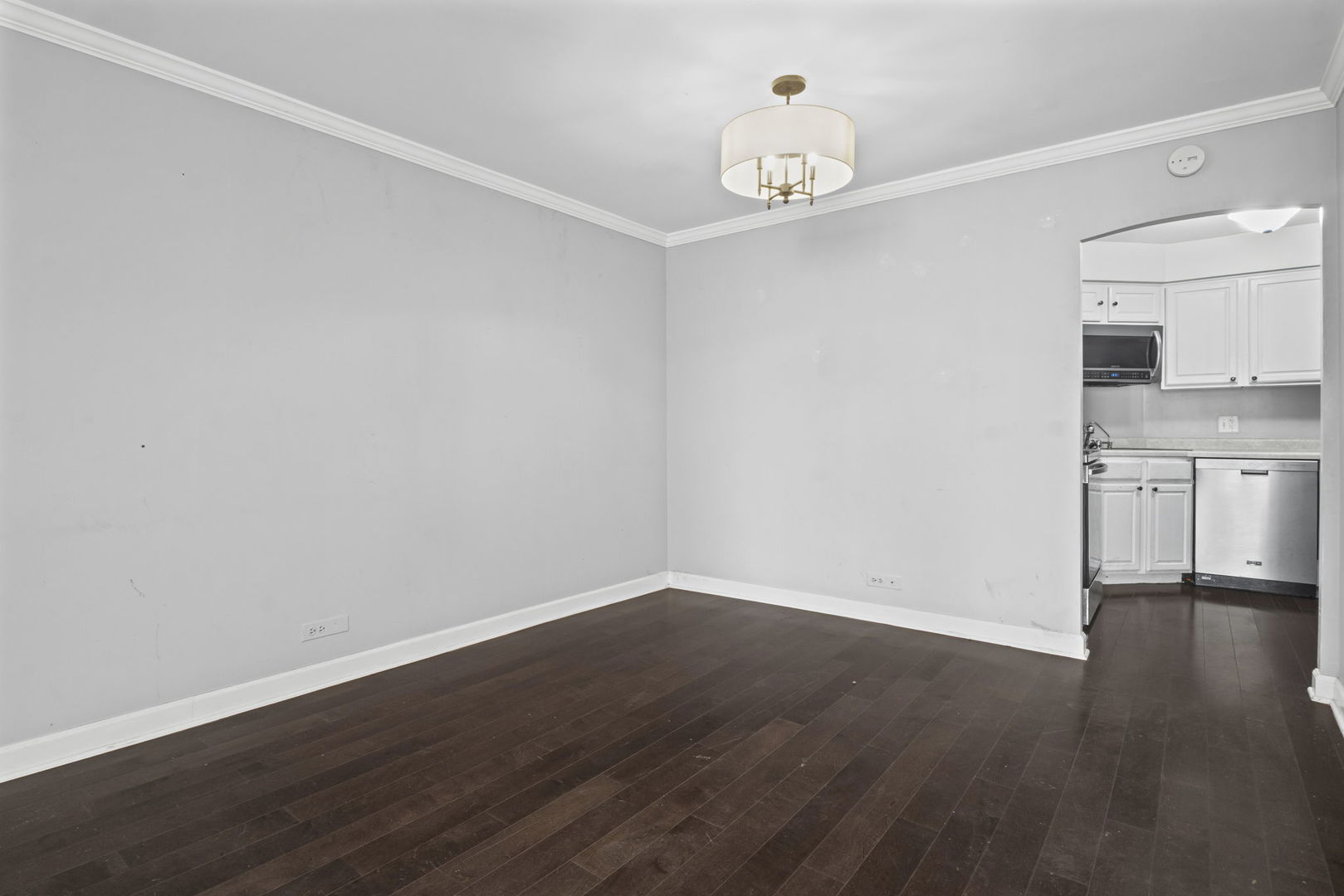 6033 North Sheridan Road, Unit 10D Chicago, IL 60660 - Photo 7 of 24 a view of a kitchen with wooden floor and a sink
