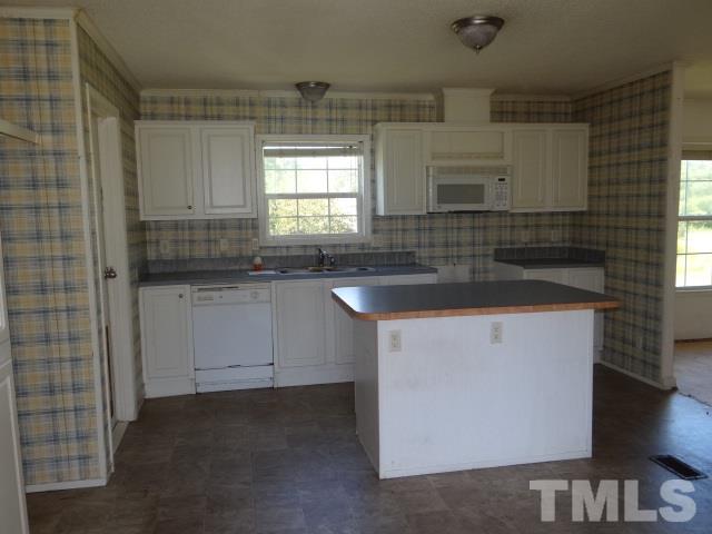 15 Beaver Run Road Spring Hope, NC 27882 - Photo 4 of 12 a kitchen with granite countertop white cabinets and sink
