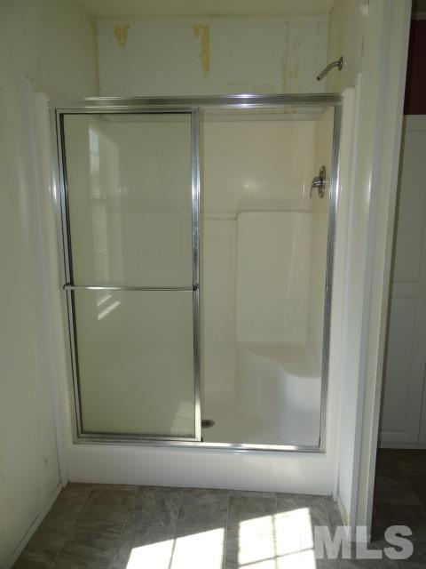 15 Beaver Run Road Spring Hope, NC 27882 - Photo 9 of 12 a bathroom with a glass shower door