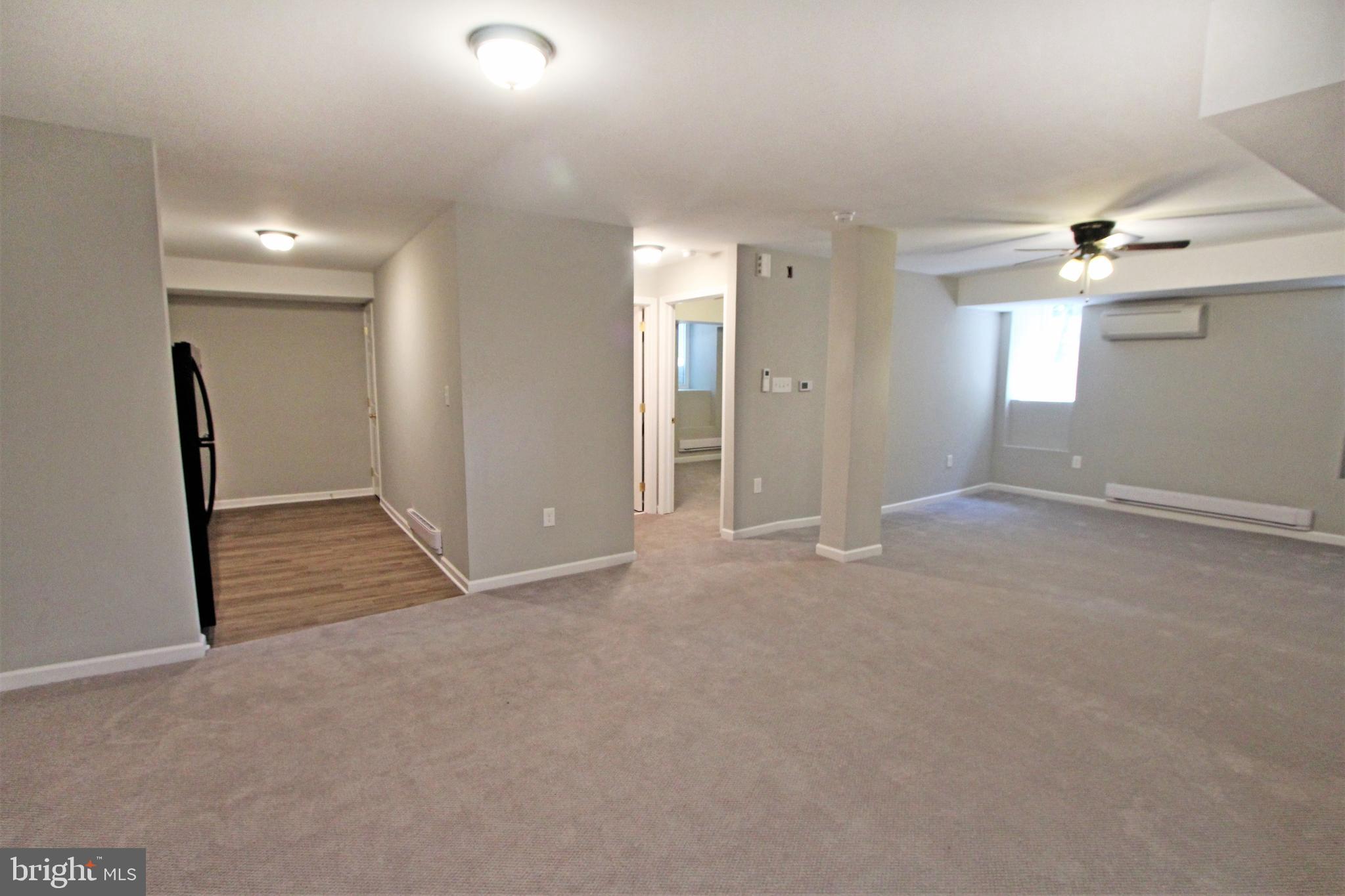 an empty room with windows and entrance