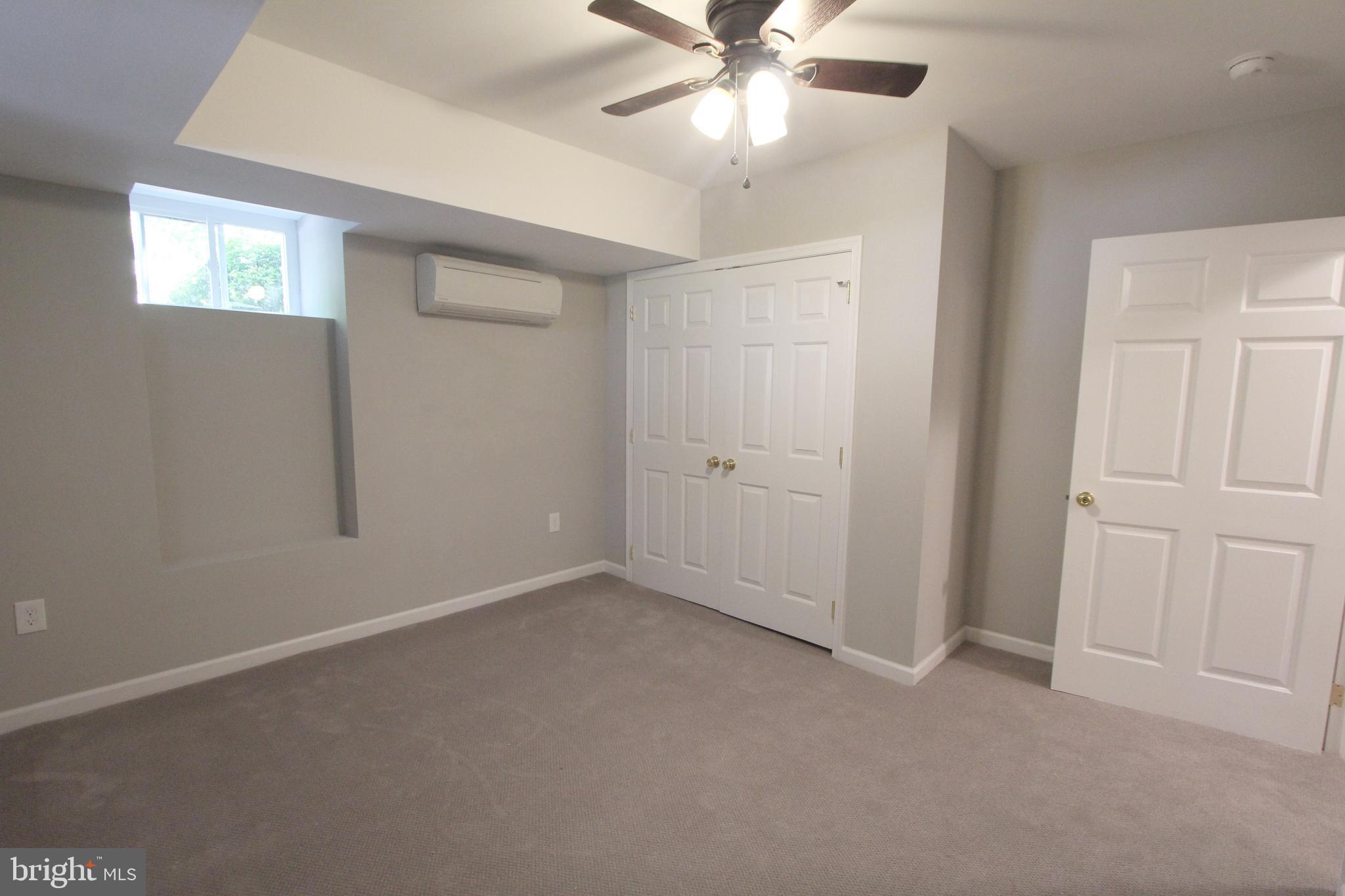 6640 Sprague Street, Unit B5 Philadelphia, PA 19119 - Photo 12 of 16 an empty room with windows and fan